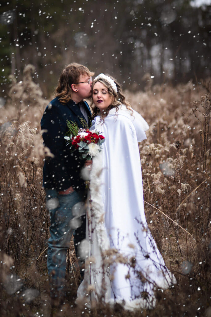 bride and groom in snow for wedding