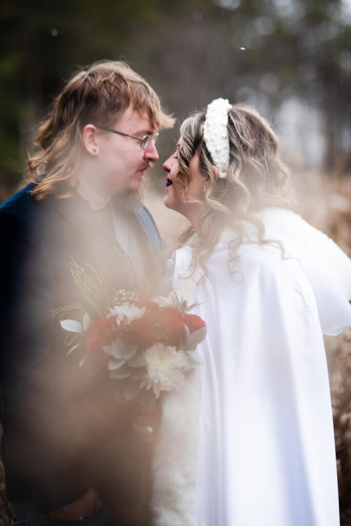 bride and groom in snow at wedding