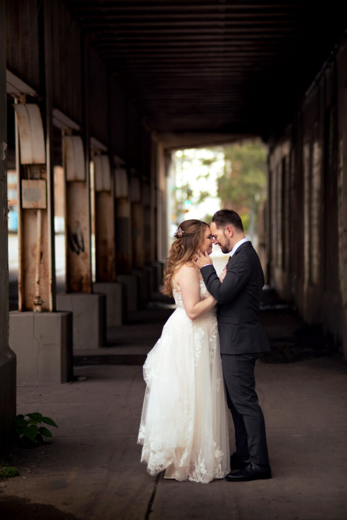 bride and groom under bridge